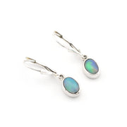 Pair of silver earrings with opal stones on a white background
