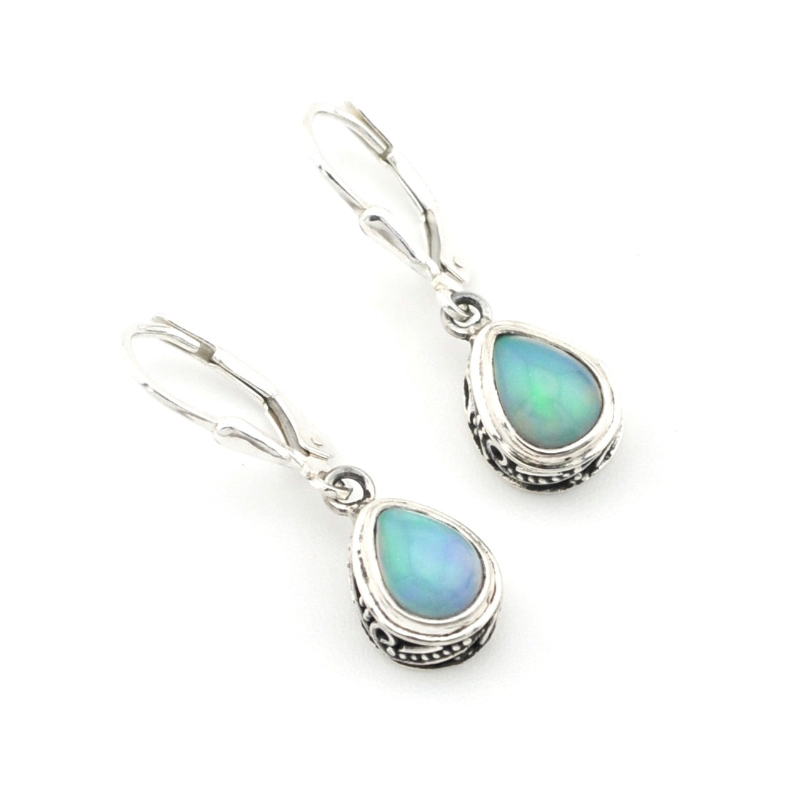 Pair of silver earrings with teardrop-shaped opal stones on a white background