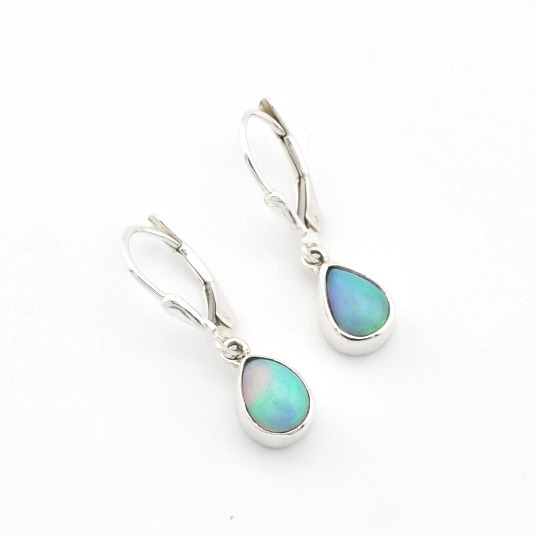 Teardrop-shaped opal earrings on a white background