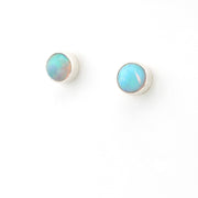 Pair of round opal earrings on a white background
