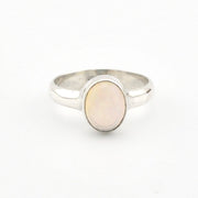 Silver ring with a light-colored stone on a white background