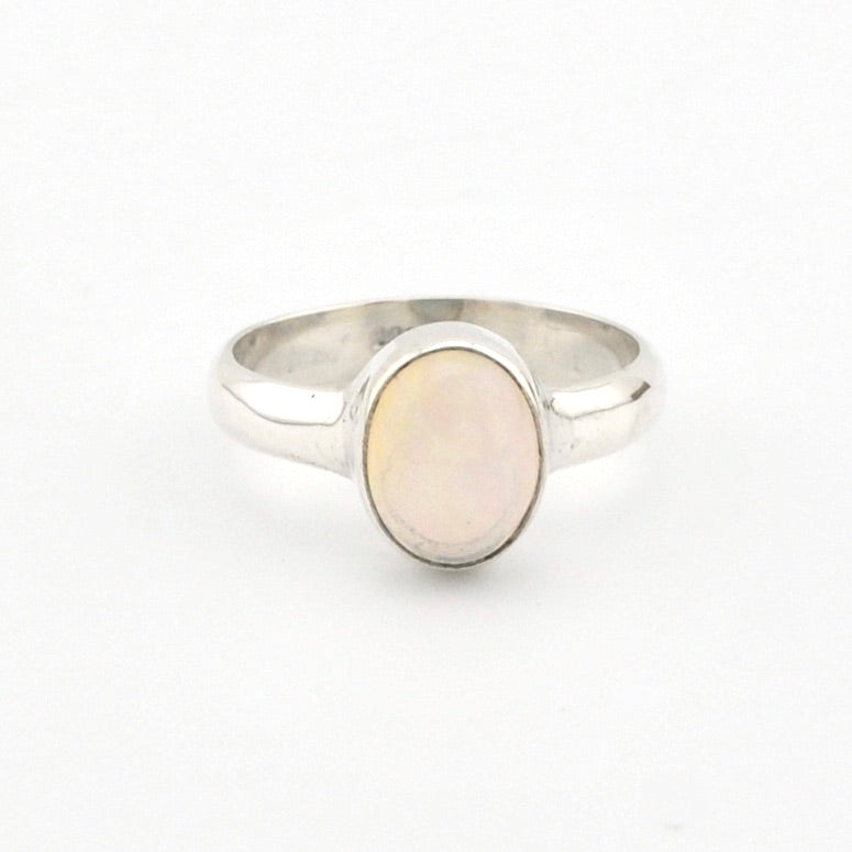 Silver ring with a light-colored stone on a white background