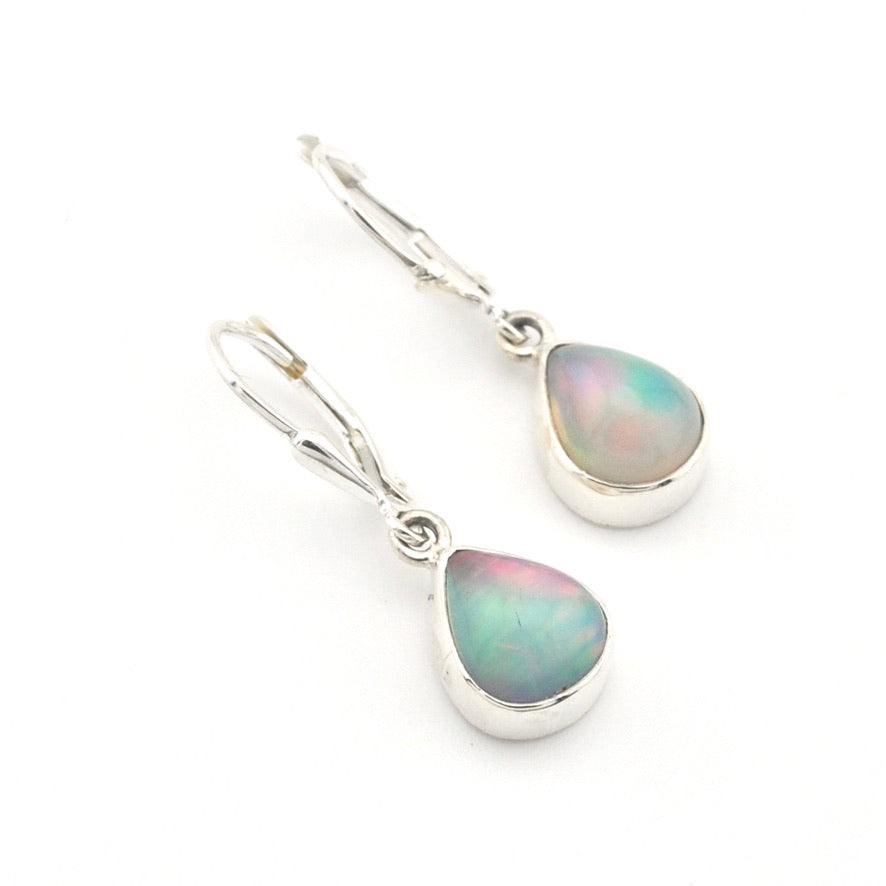 Pair of silver earrings with teardrop-shaped opal stones on a white background