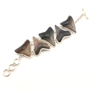 Bracelet with black triangular stones and silver chain on a white background