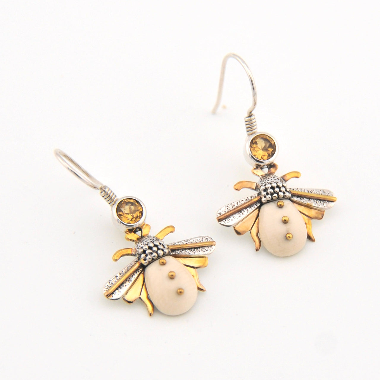 Bee-shaped earrings with gold and silver details on a white background