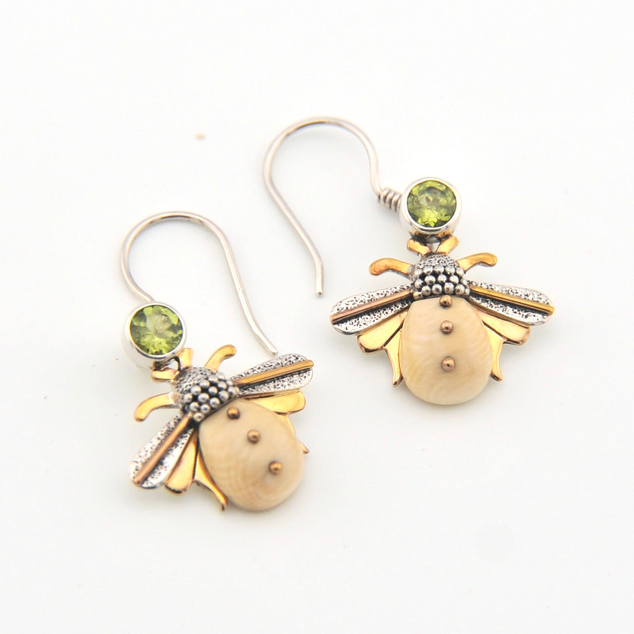 Bee-shaped earrings with gold and silver details on a white background