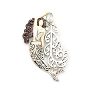 Mermaid-shaped pendant with intricate designs on a white background