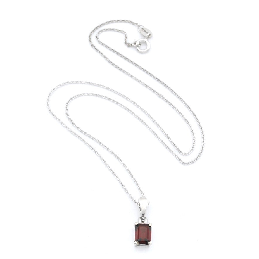 A silver chain necklace with a rectangular dark red gemstone pendant, displayed on a clean white background.