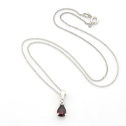 A silver chain necklace with a teardrop-shaped dark red gemstone pendant, displayed on a clean white background.