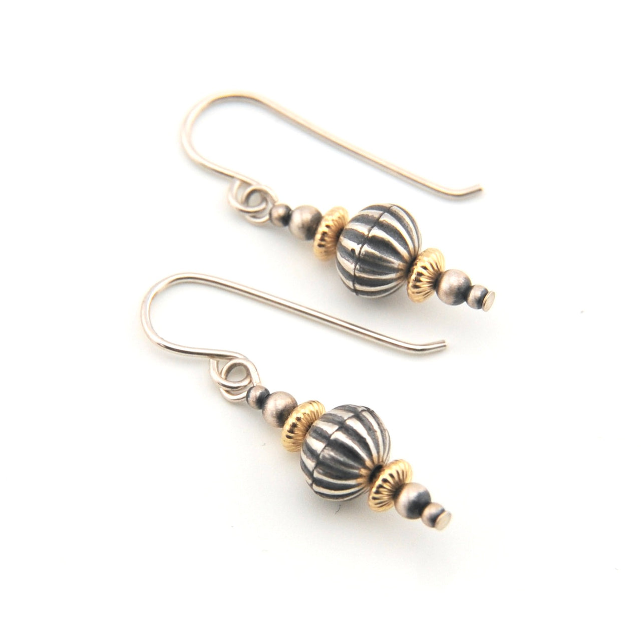 Pair of earrings with striped beads on a white background