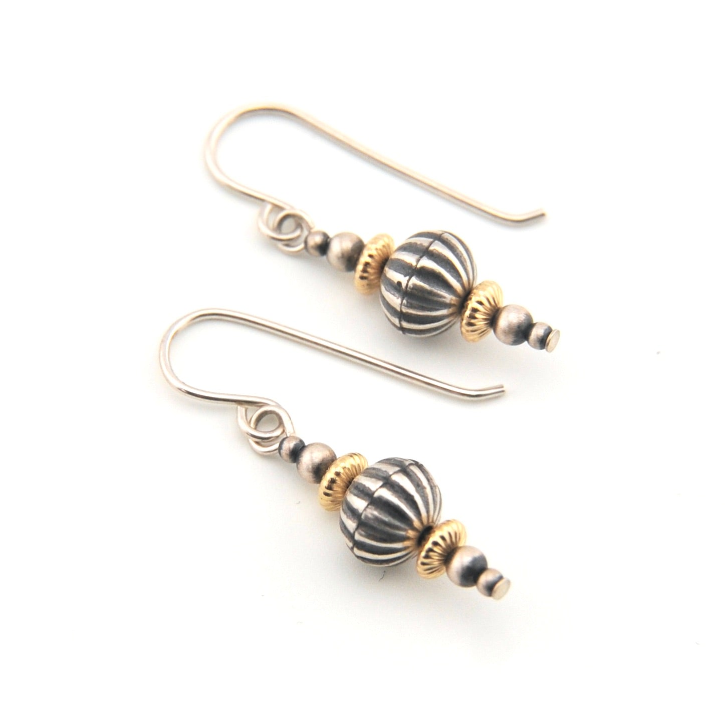 Pair of earrings with striped beads on a white background