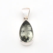 Teardrop-shaped green gemstone pendant on a white background