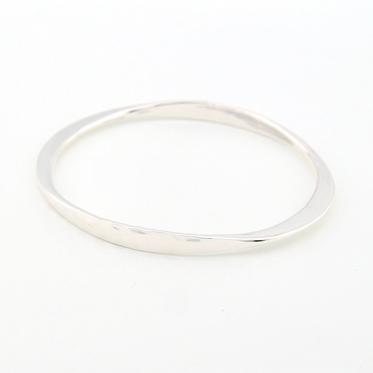 Silver bangle on a white background