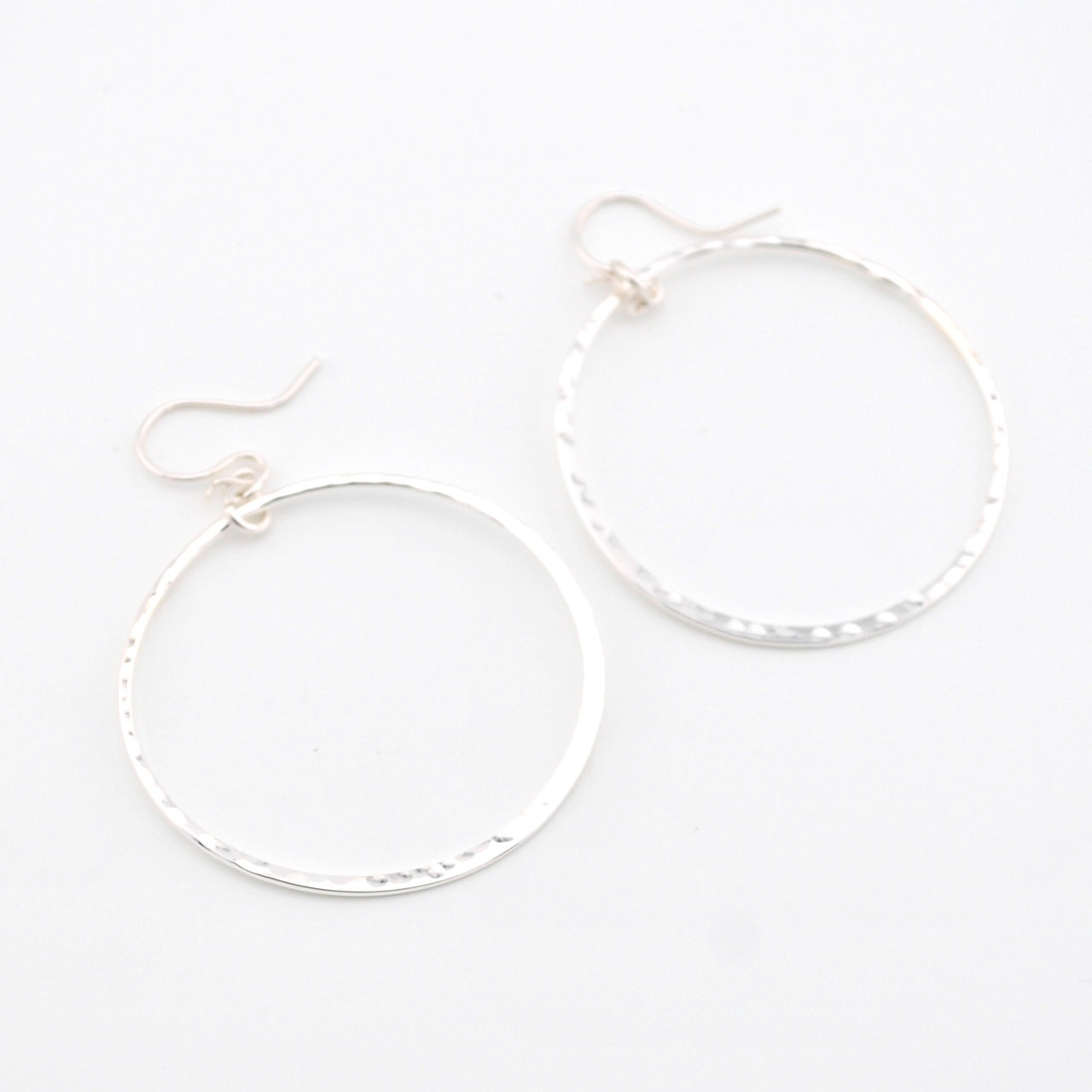 Silver hoop earrings on a white background