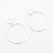 Silver hoop earrings on a white background