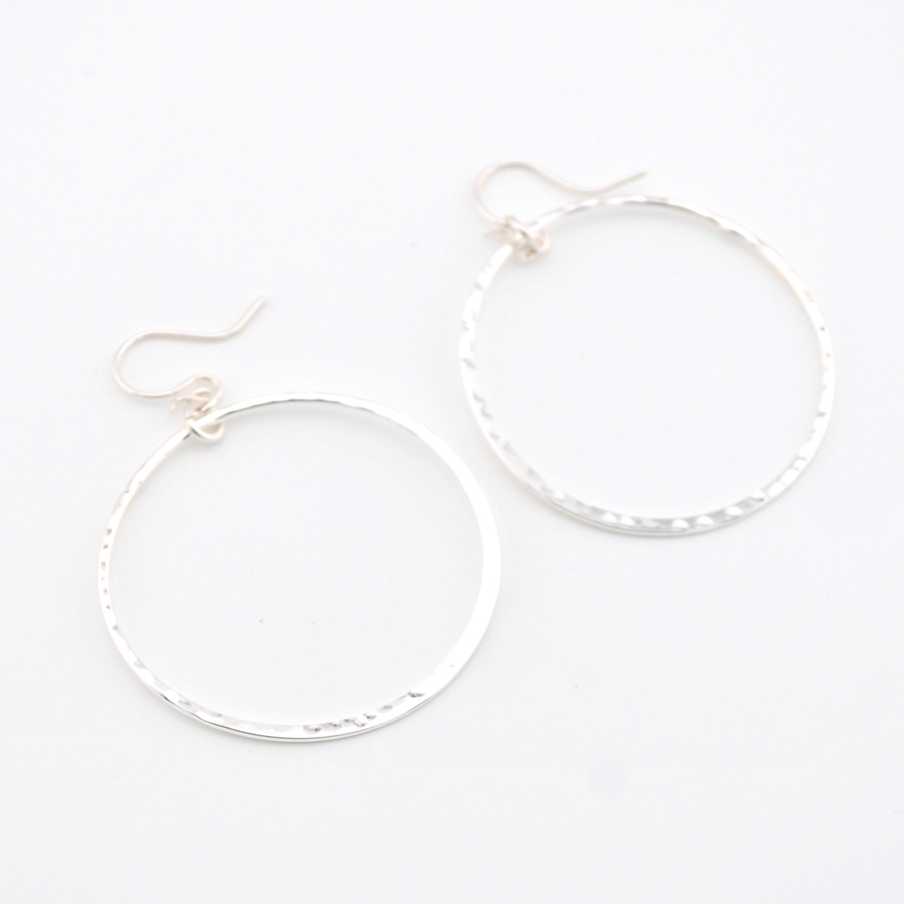 Silver hoop earrings on a white background