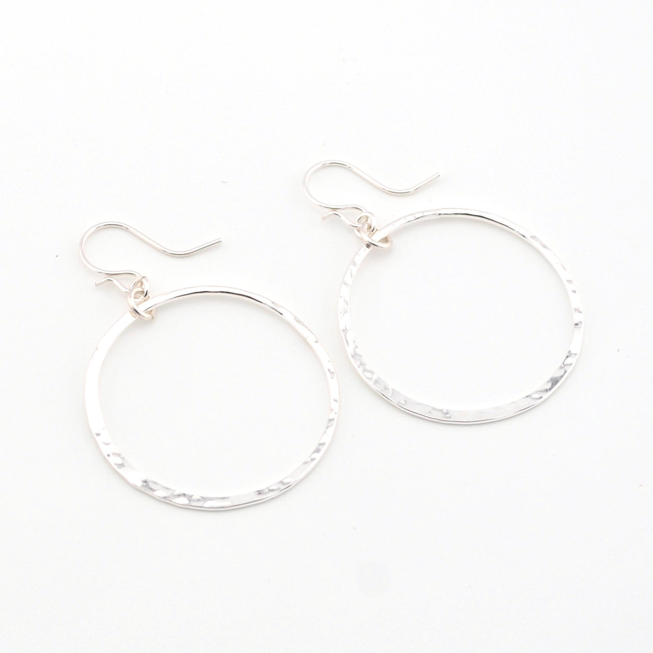Silver hoop earrings on a white background
