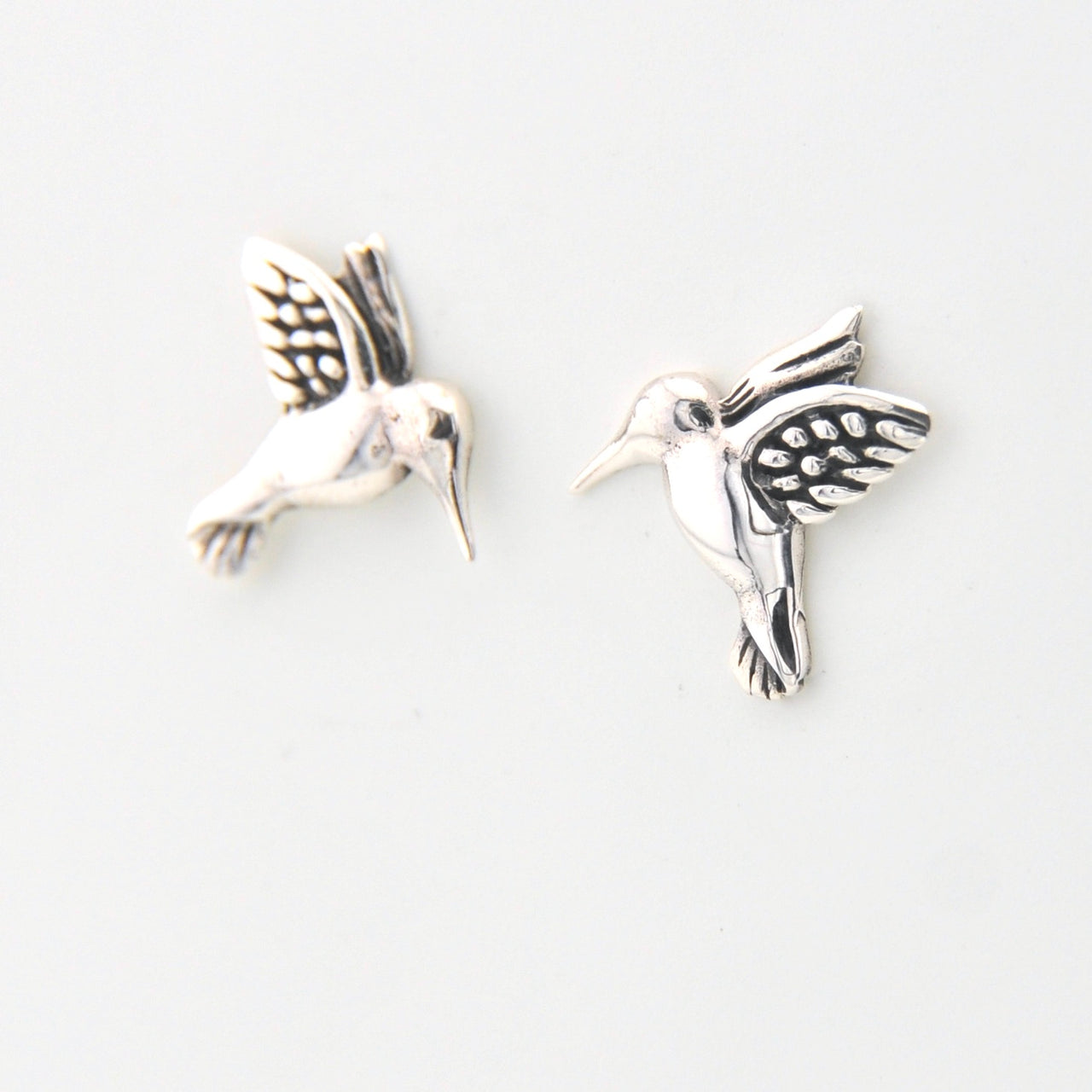 Silver hummingbird earrings on a white background