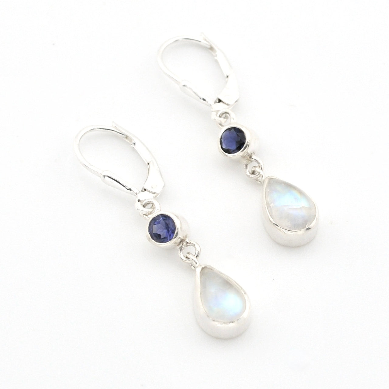 Silver earrings with teardrop-shaped gemstones on a white background