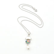 Silver necklace with a colorful pendant on a white background