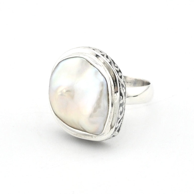 Silver ring with keshi pearl on white background.