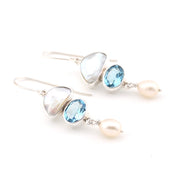Pair of earrings with blue gemstones and pearls on a white background