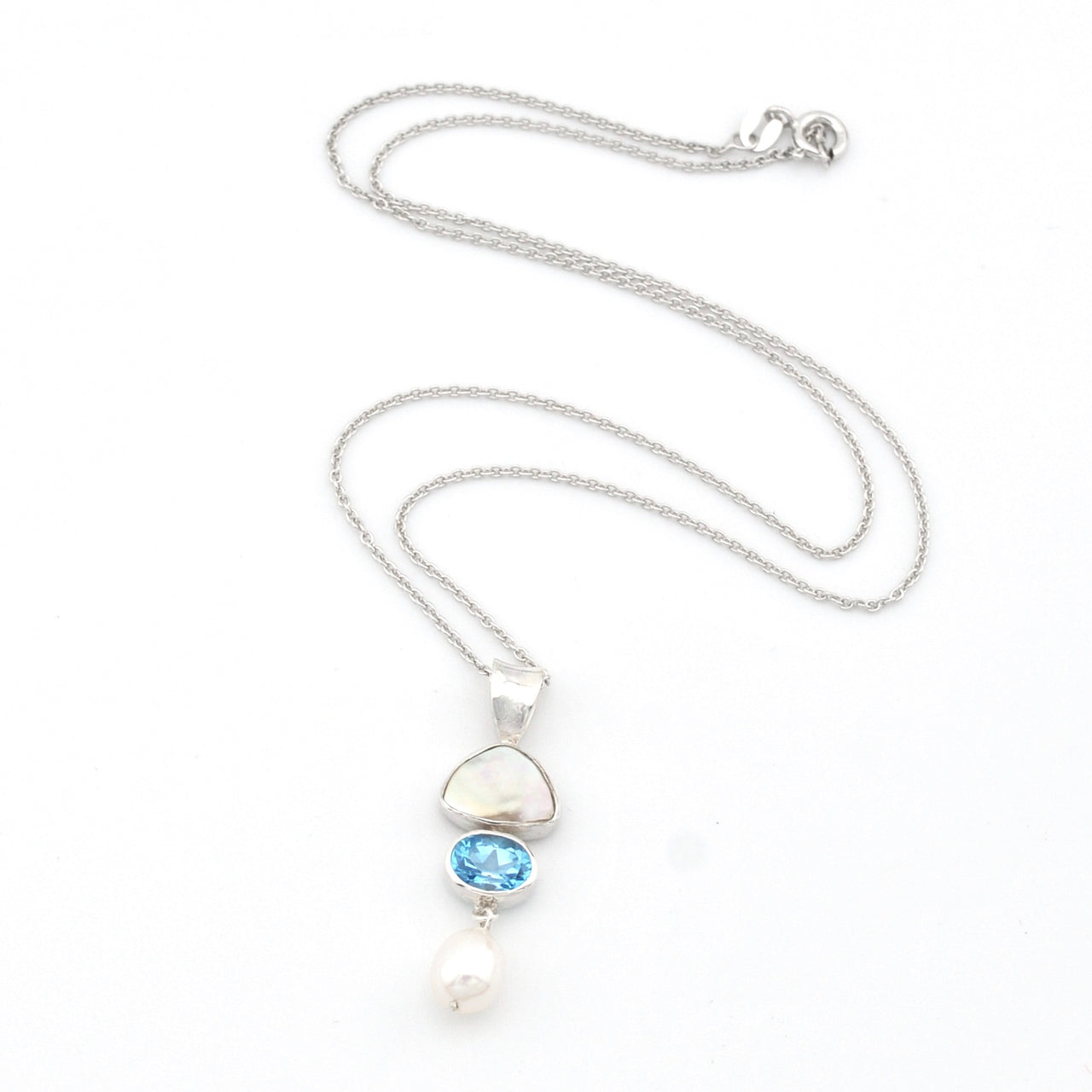 Necklace with a pendant featuring a blue gemstone and pearl on a white background