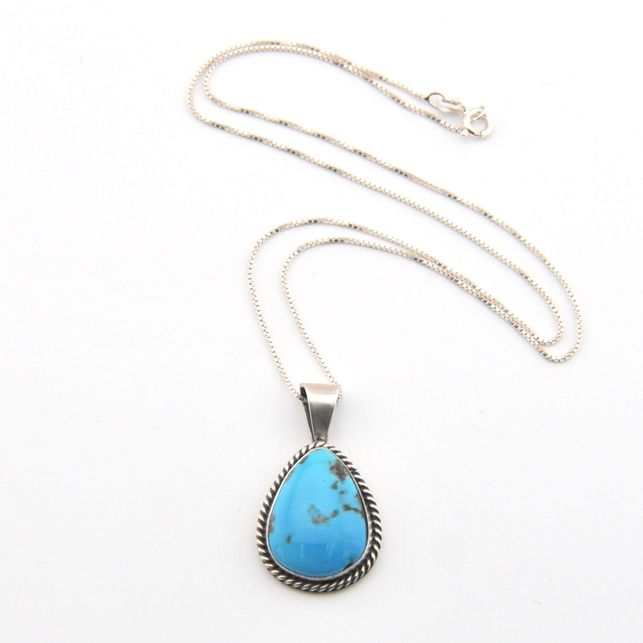 Turquoise pendant necklace on a white background