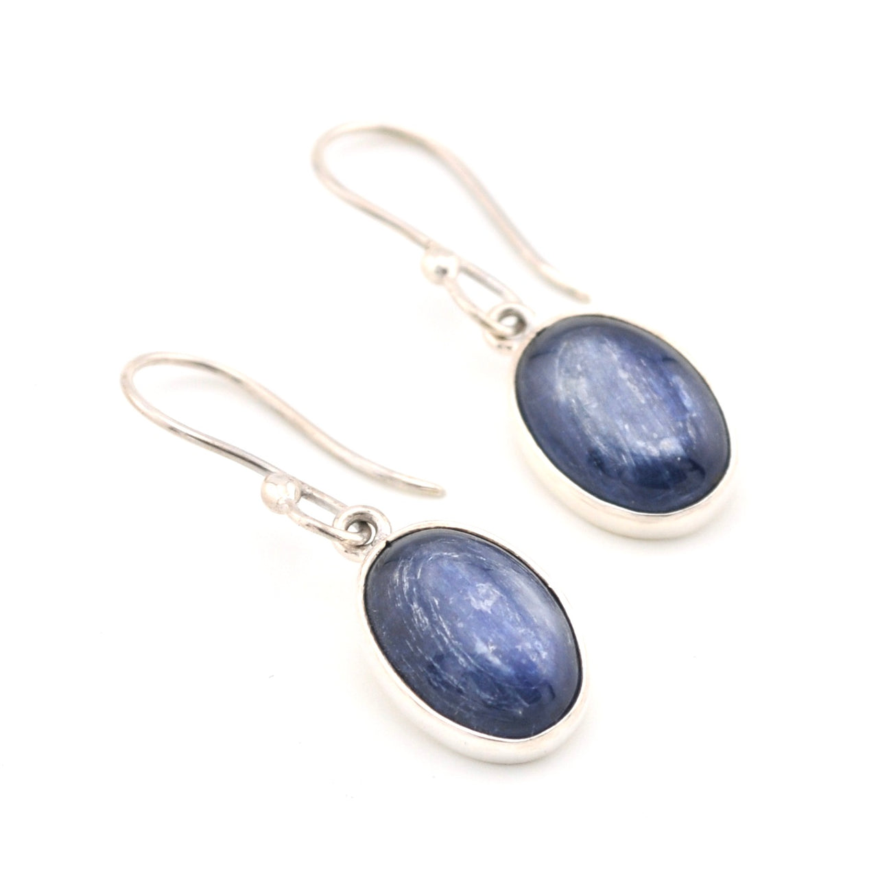 Pair of blue oval stone earrings with silver hooks on a white background