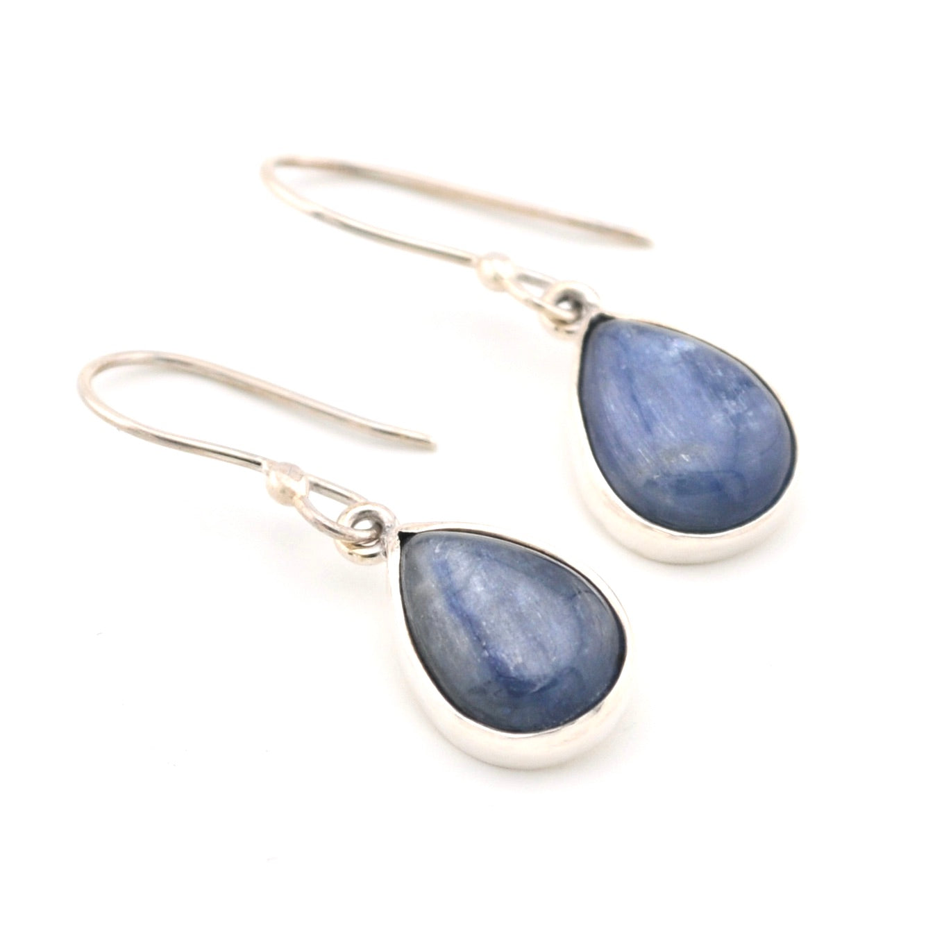 Teardrop-shaped blue gemstone earrings on a white background