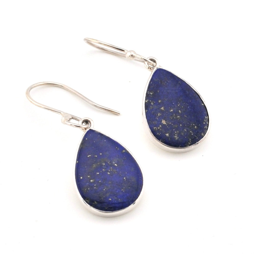 Teardrop-shaped lapis lazuli earrings with silver hooks on a white background
