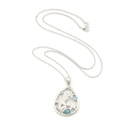 Silver necklace with a teardrop-shaped pendant featuring a horse design on a white background