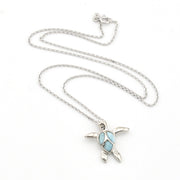 Silver turtle pendant necklace with a blue stone on a white background