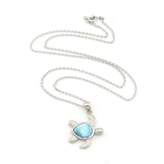 Sea turtle necklace with larimar stone on white background.
