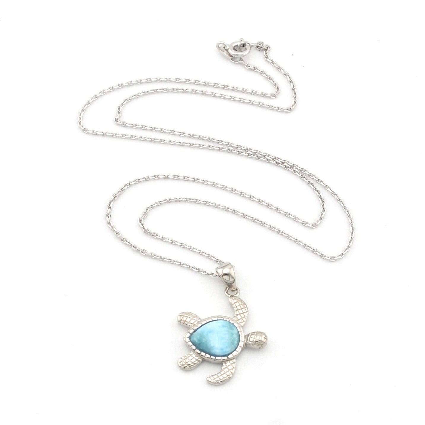 Sea turtle necklace with larimar stone on white background.