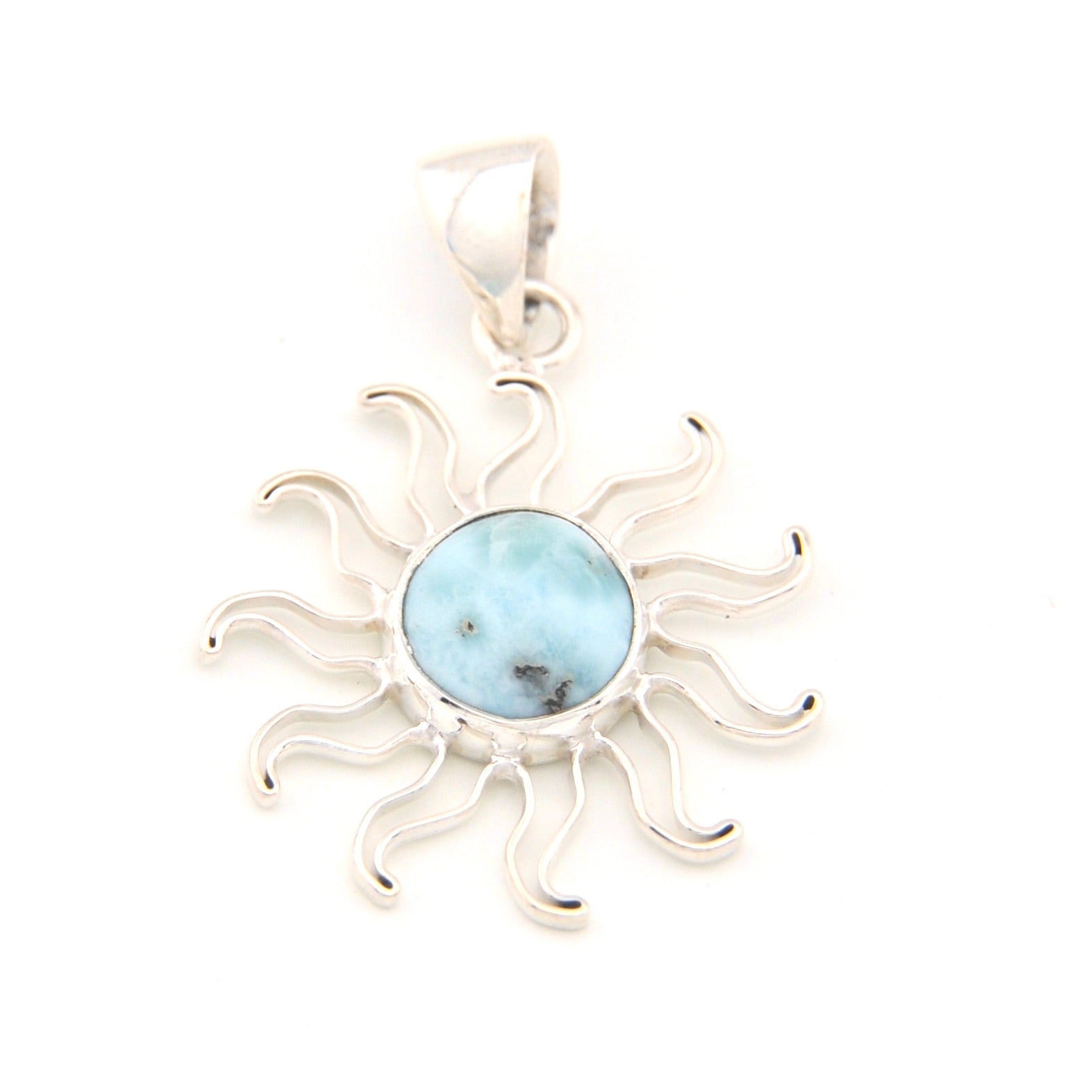 Silver sun-shaped pendant with a blue stone on a white background