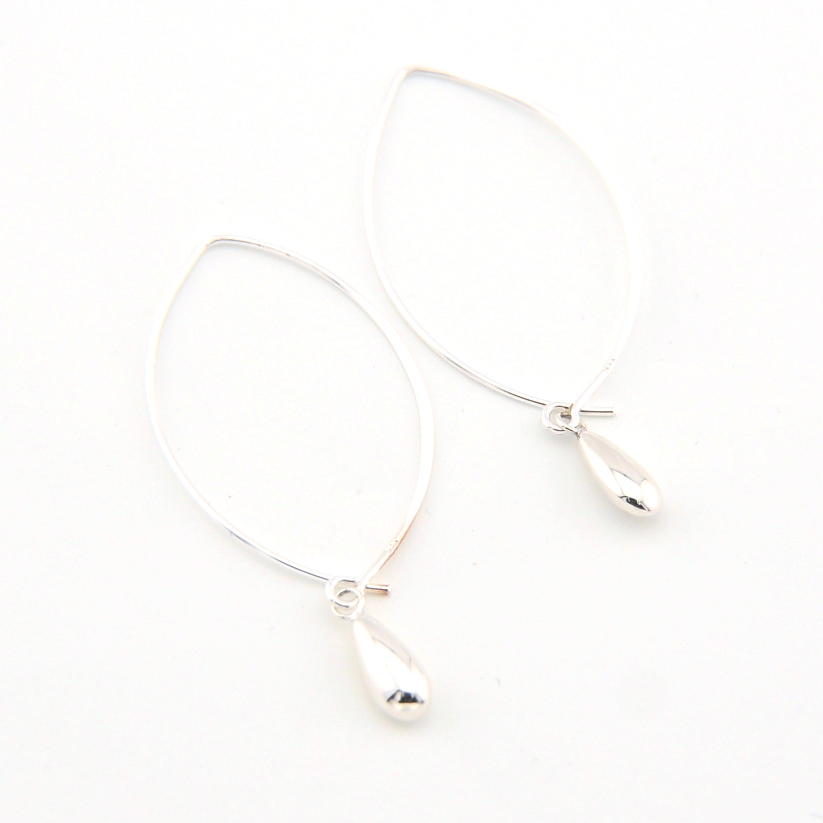 Silver earrings on a white background