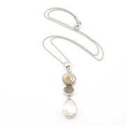 Necklace with a pendant featuring natural stones on a white background