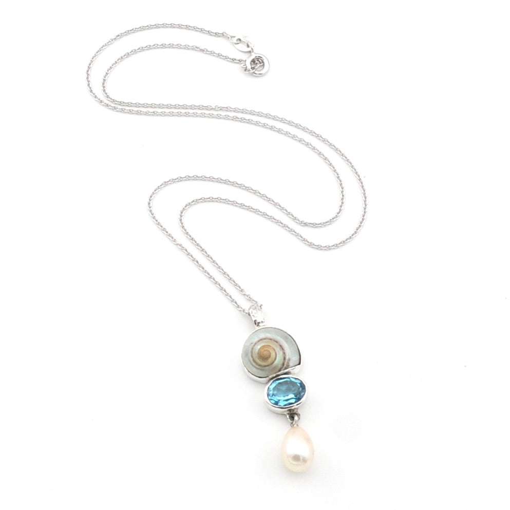 Necklace with a pendant featuring a pearl, blue gemstone, and silver elements on a white background