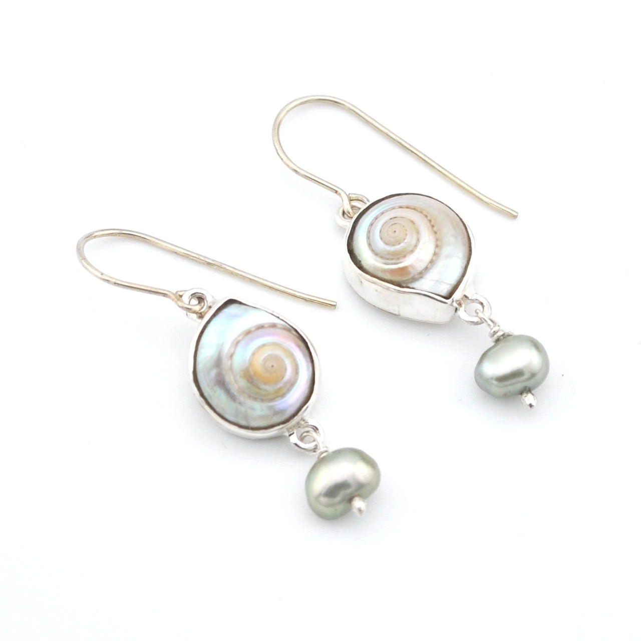Pair of silver earrings with circular and teardrop-shaped pearl elements on a white background