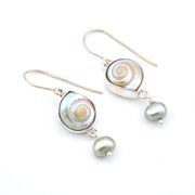 Pair of silver earrings with circular and teardrop-shaped pearl elements on a white background