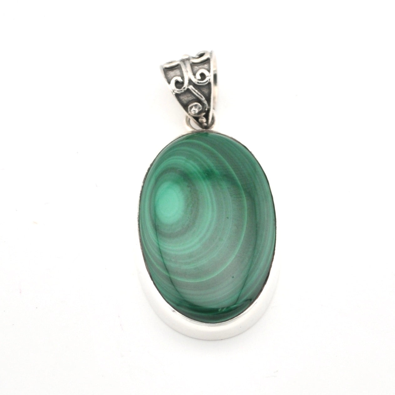 Green malachite pendant with silver setting on a white background