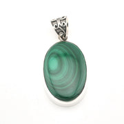 Green malachite pendant with silver setting on a white background