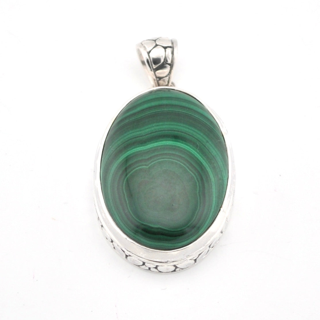 Green stone pendant with silver setting on a white background