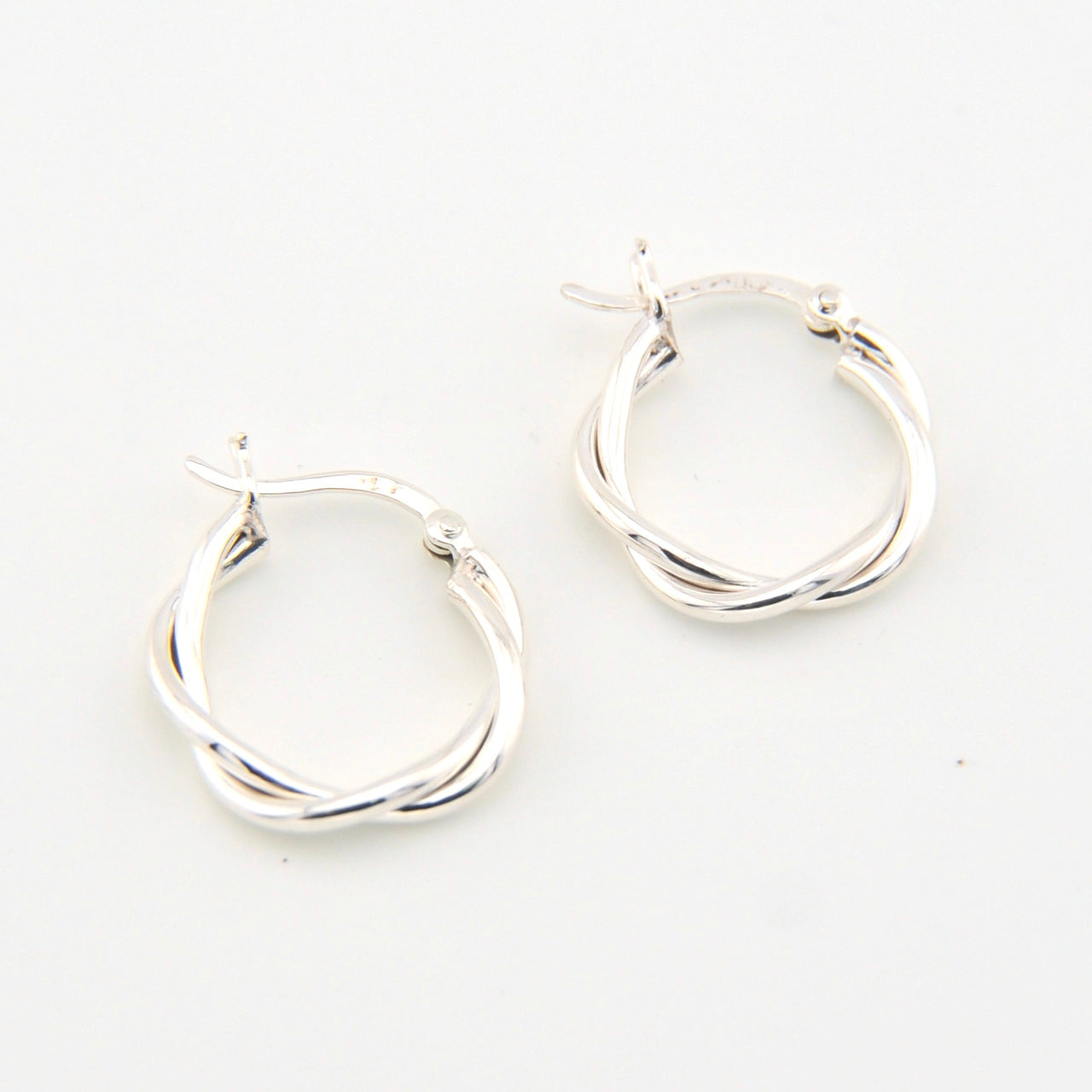 Silver hoop earrings on a white background