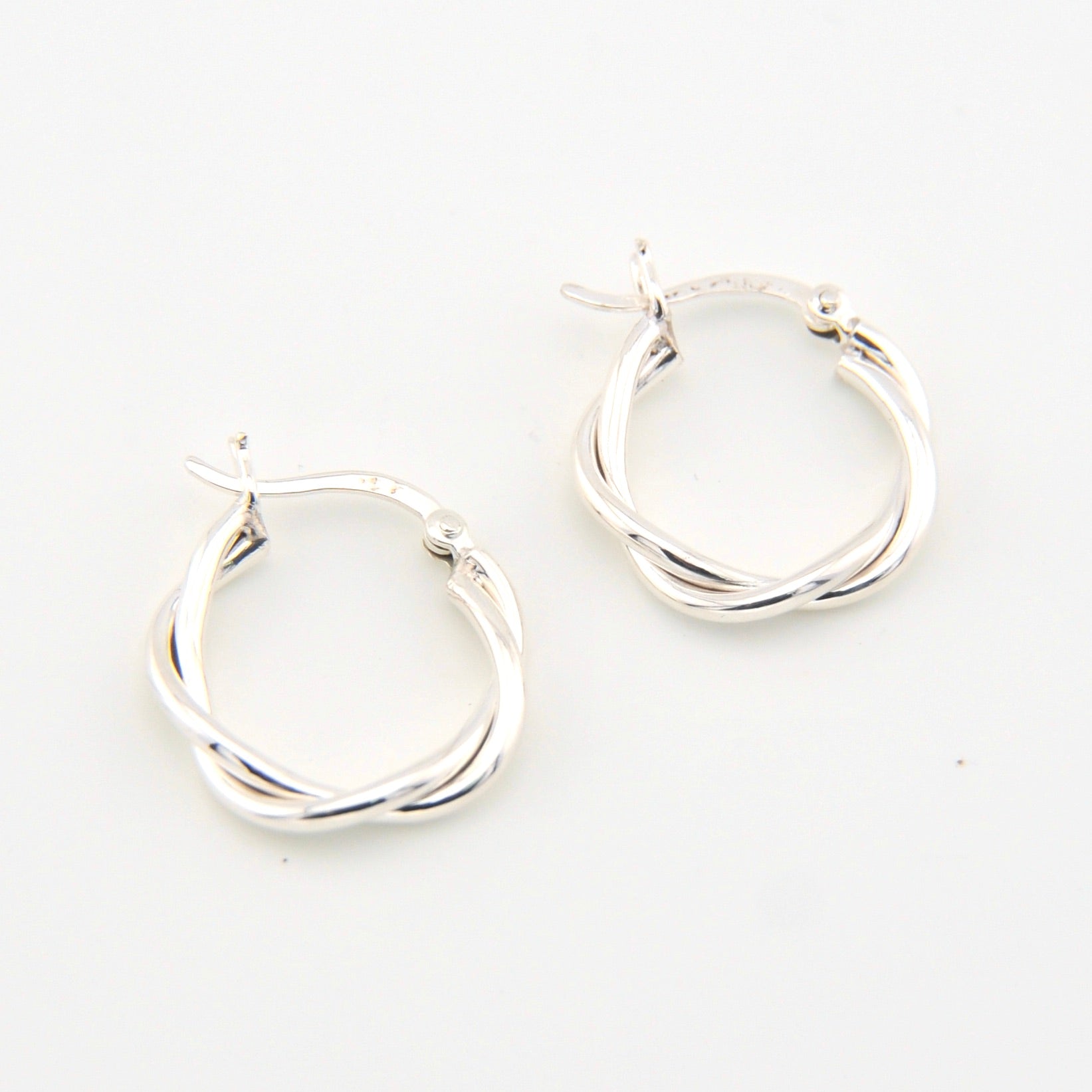 Silver hoop earrings on a white background