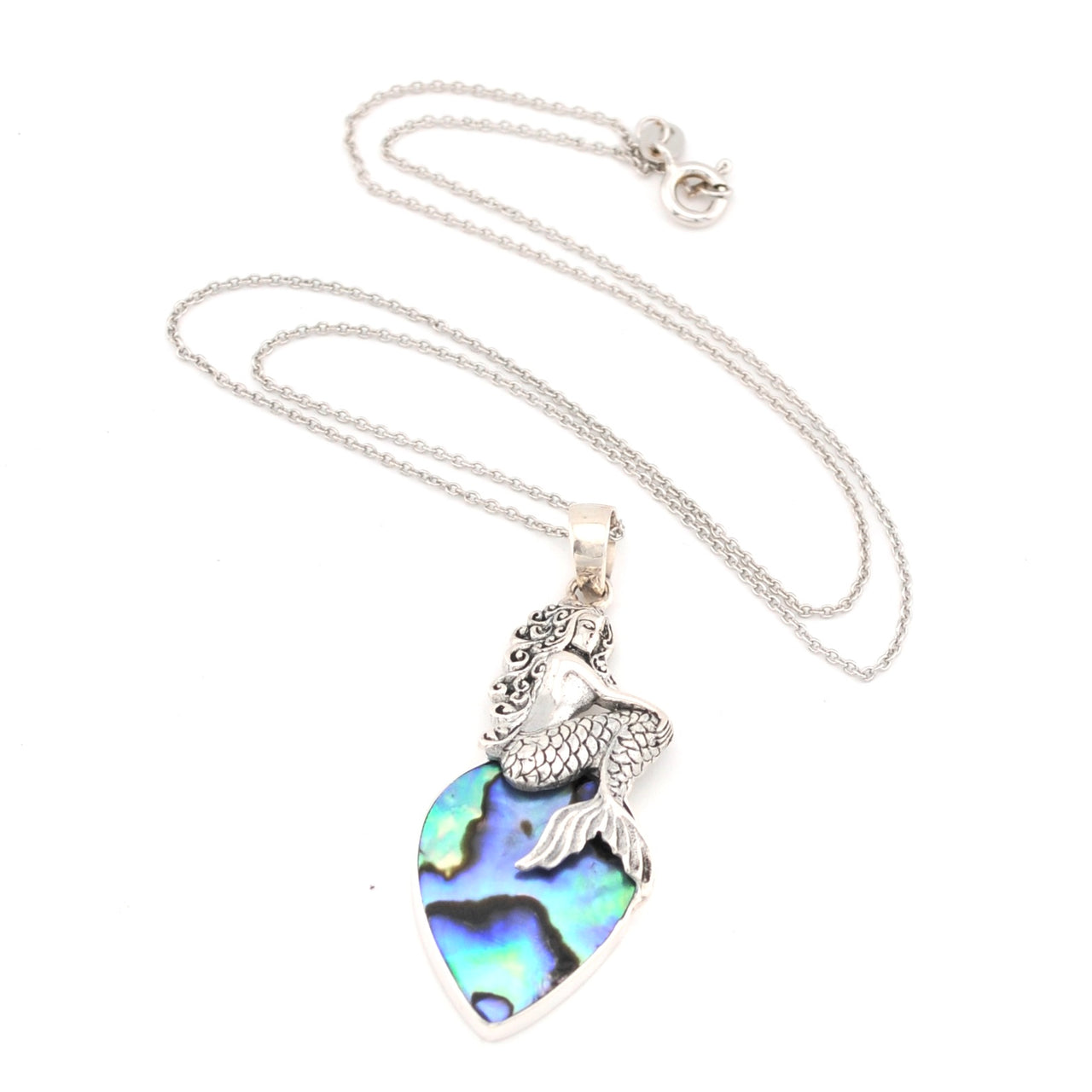 Necklace with a heart-shaped abalone shell pendant and mermaid tail charm on a white background