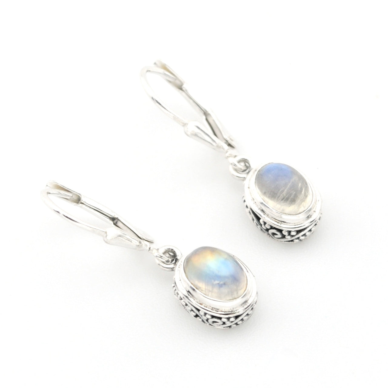 Silver earrings with rainbow moonstone stones on a white background