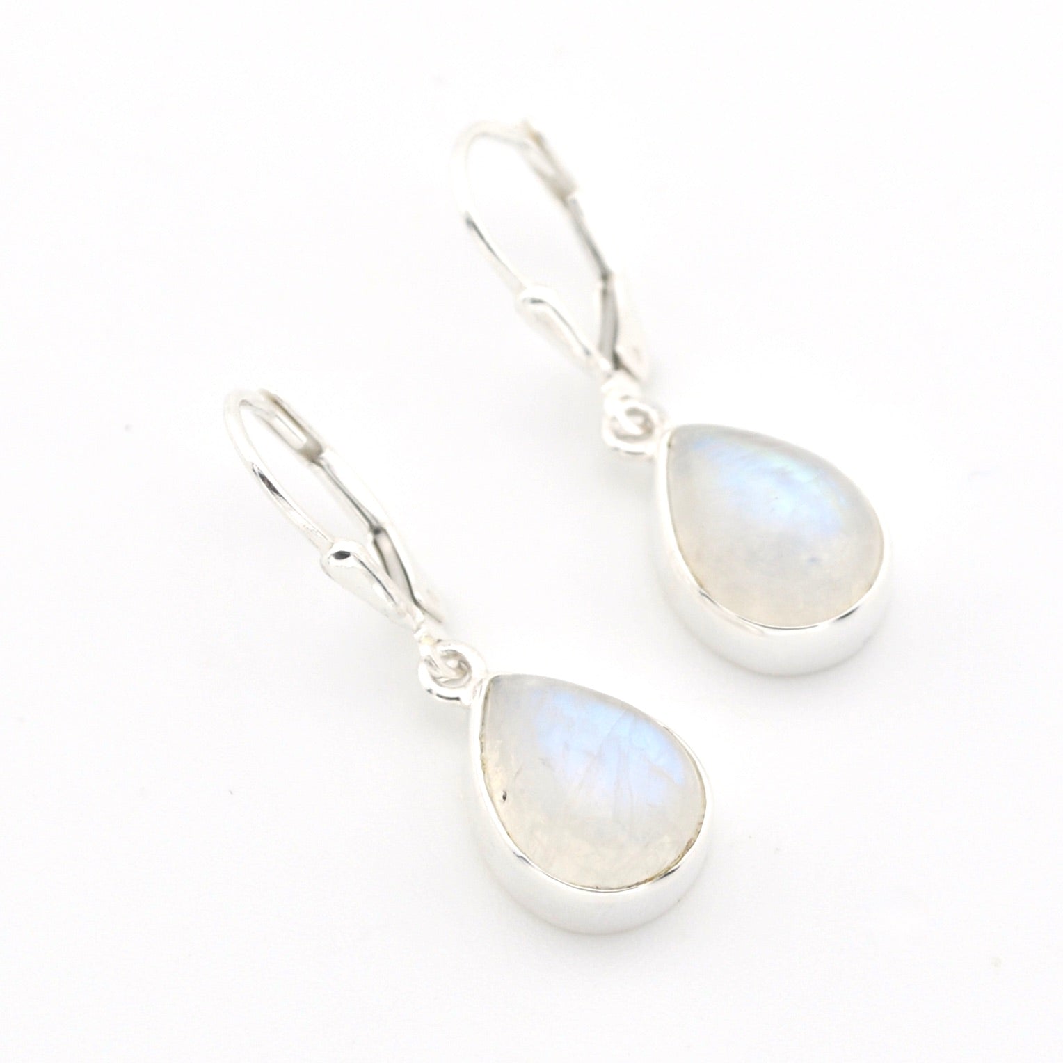 Teardrop-shaped earrings with rainbow moonstone stones on a white background