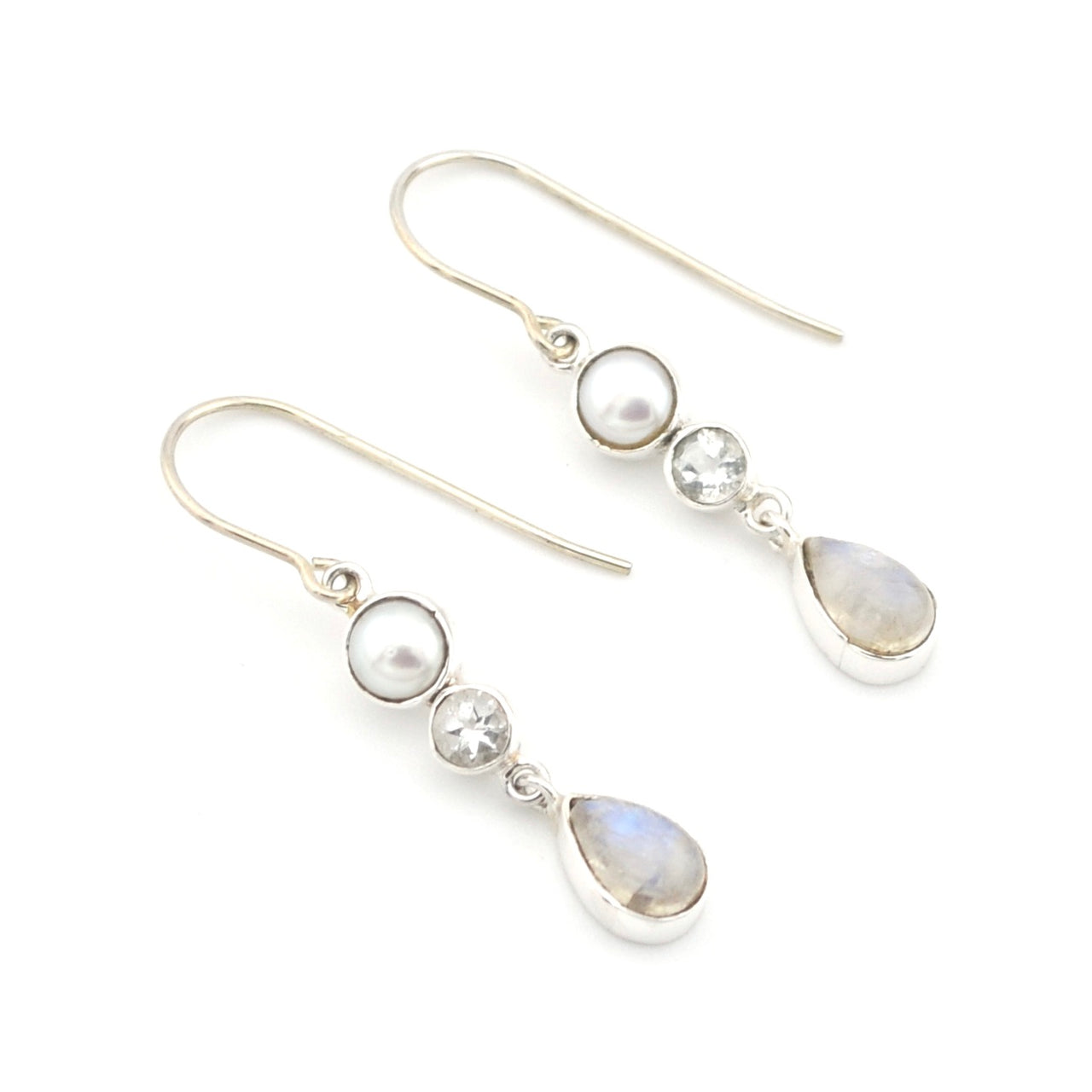 Pair of earrings with pearls and teardrop-shaped stones on a white background